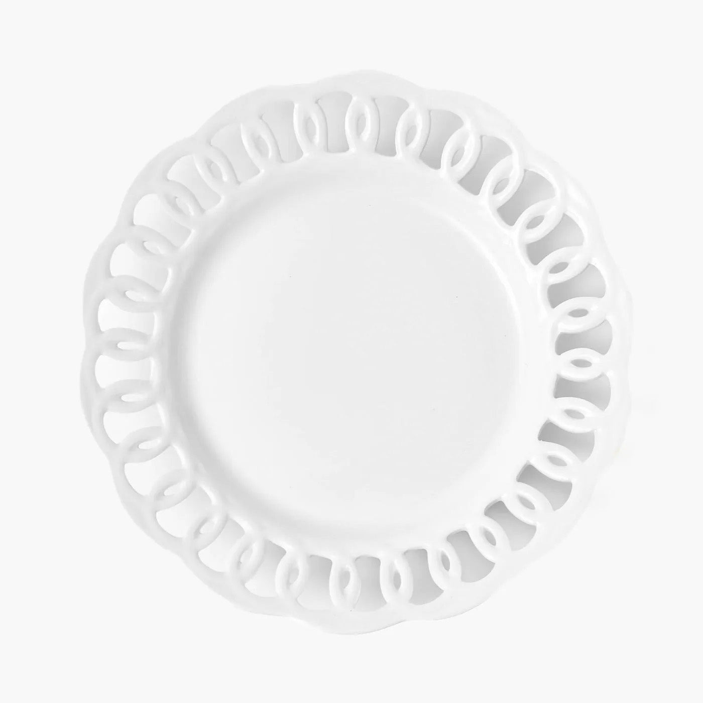 A white dinner plate with a lace pattern rim.