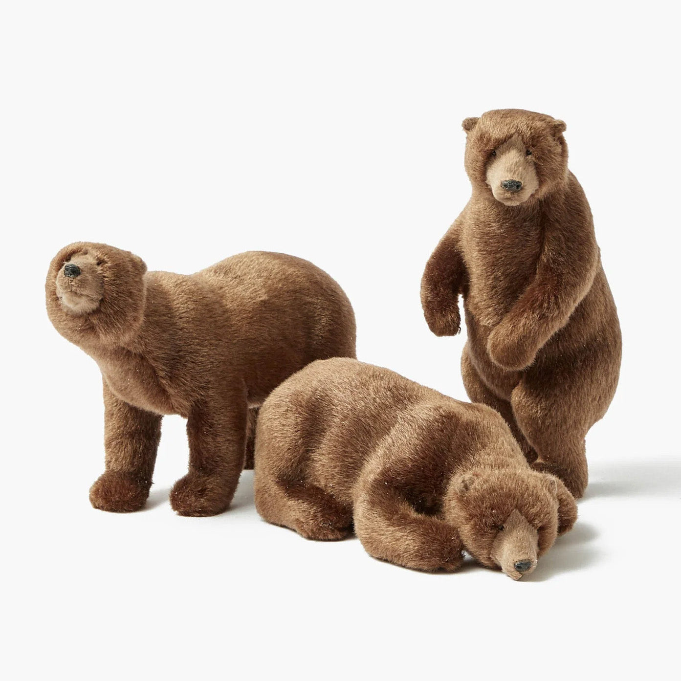 A set of three large plush Alpine brown bears in various sitting and standing positions.
