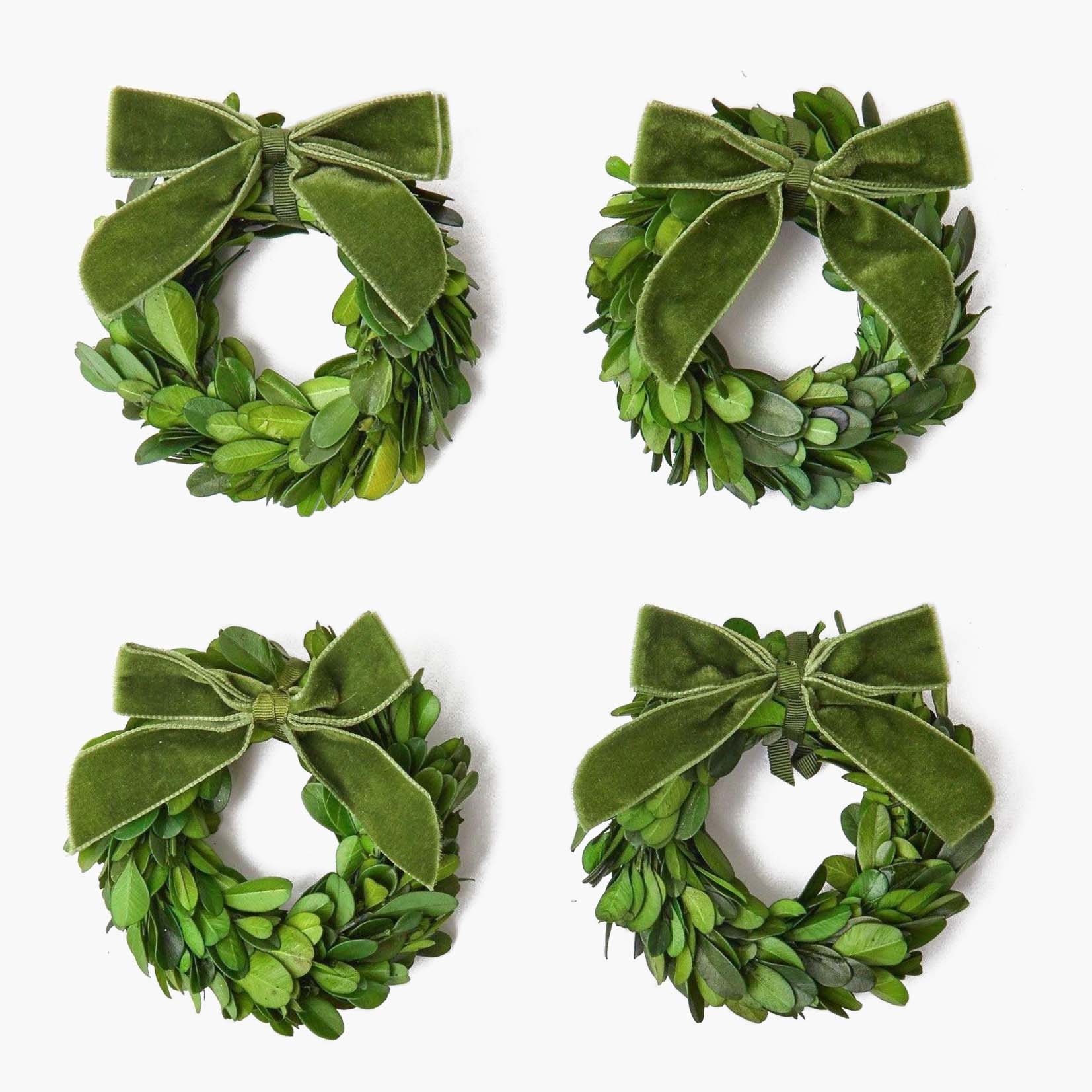 Enhance your Christmas decor with the timeless beauty of the Set of 4 Boxwood Wreaths, perfect for creating a warm and inviting atmosphere throughout your home.