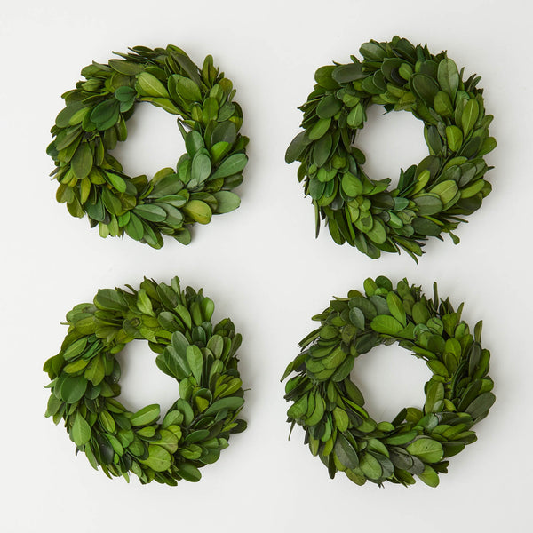 Transform your space into a winter wonderland with our Set of 4 Boxwood Wreaths - a collection of festive and welcoming decorations for the holiday season.