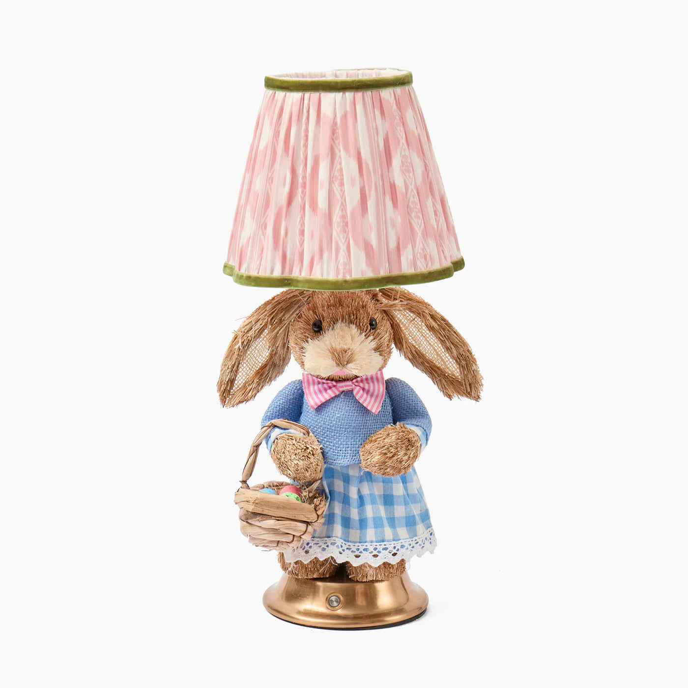 Decorative lamp with a rabbit figure holding a basket on a white background