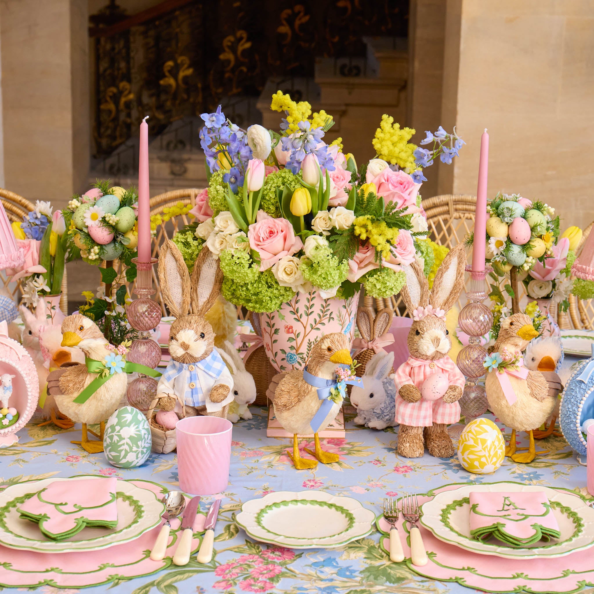 Easter-themed table setting with decorative animals and flowers.