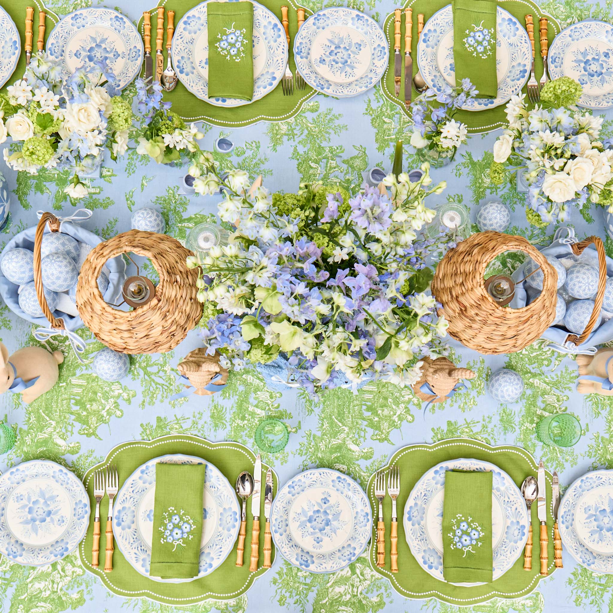 Easter-themed table setting with plates, napkins, and floral decorations.