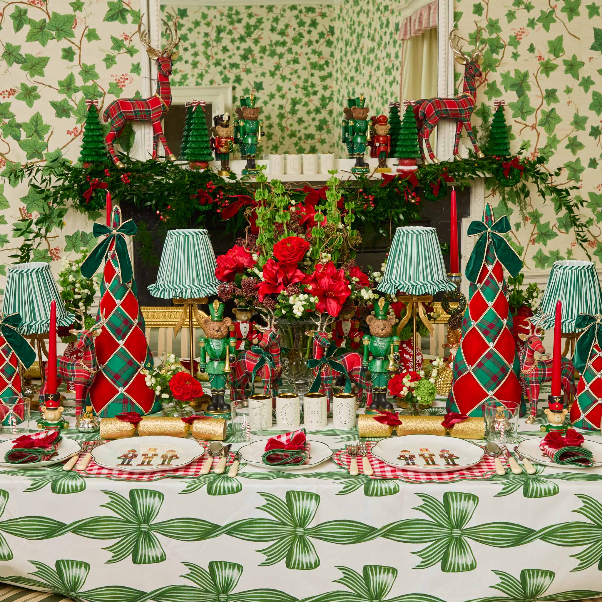 Decorative Christmas table setting with red and green accents, including tablecloths and centerpieces.