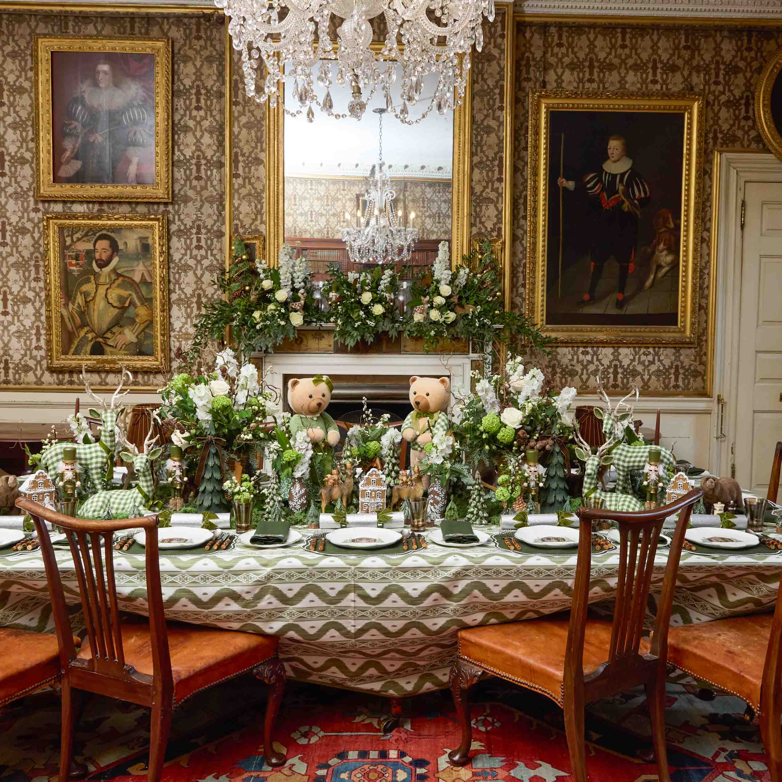 Decorative dining room with teddy bears, floral arrangements, and ornate wall portraits.