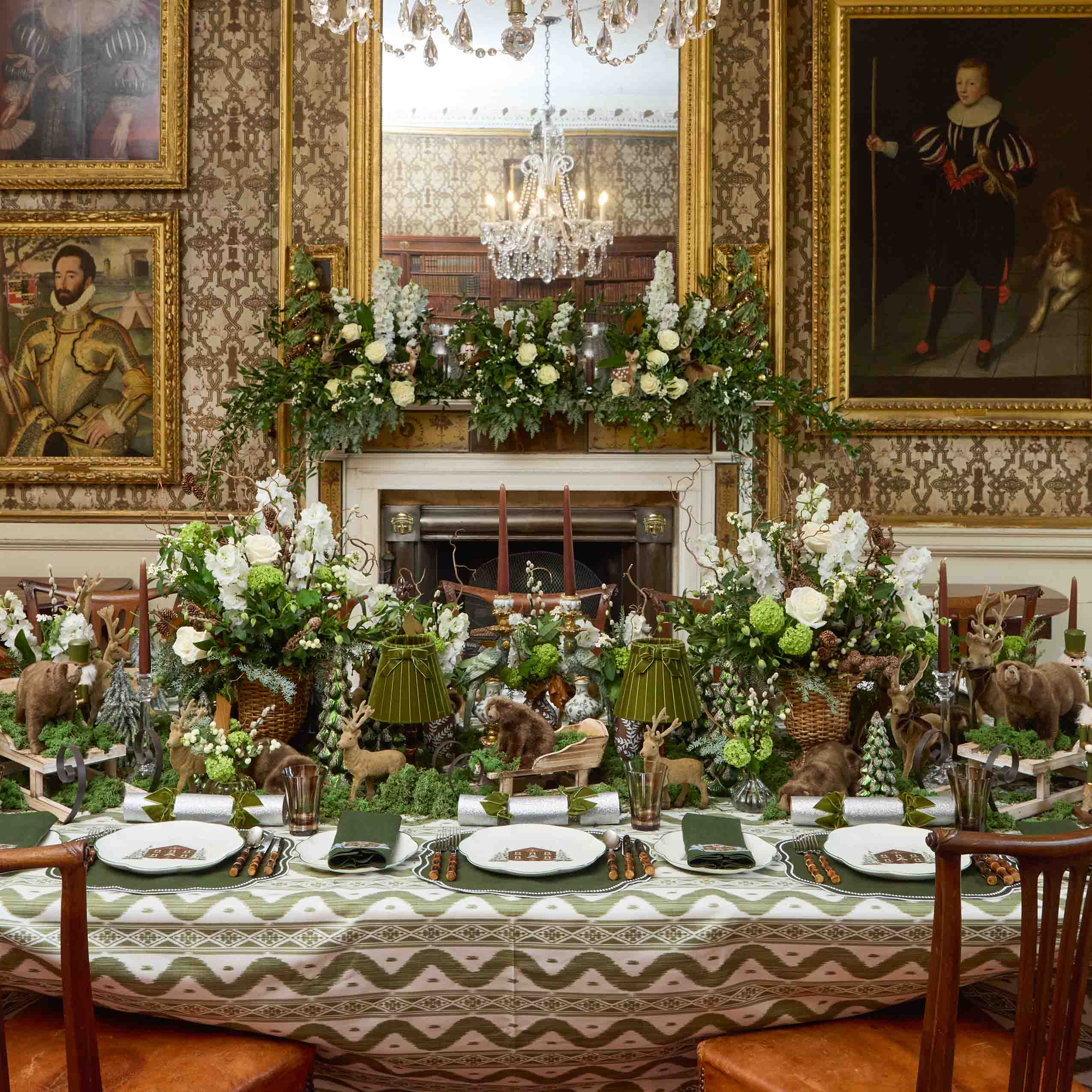 Decorative table setting in an ornate room with floral arrangements and animal figurines.