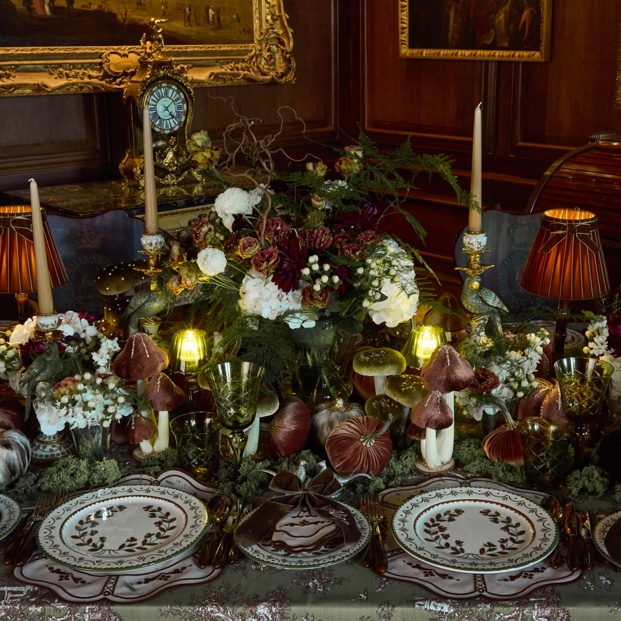 Decorative table setting with flowers, candles, and ornate plates - Mrs Alice Enchanted woodland tablescape.