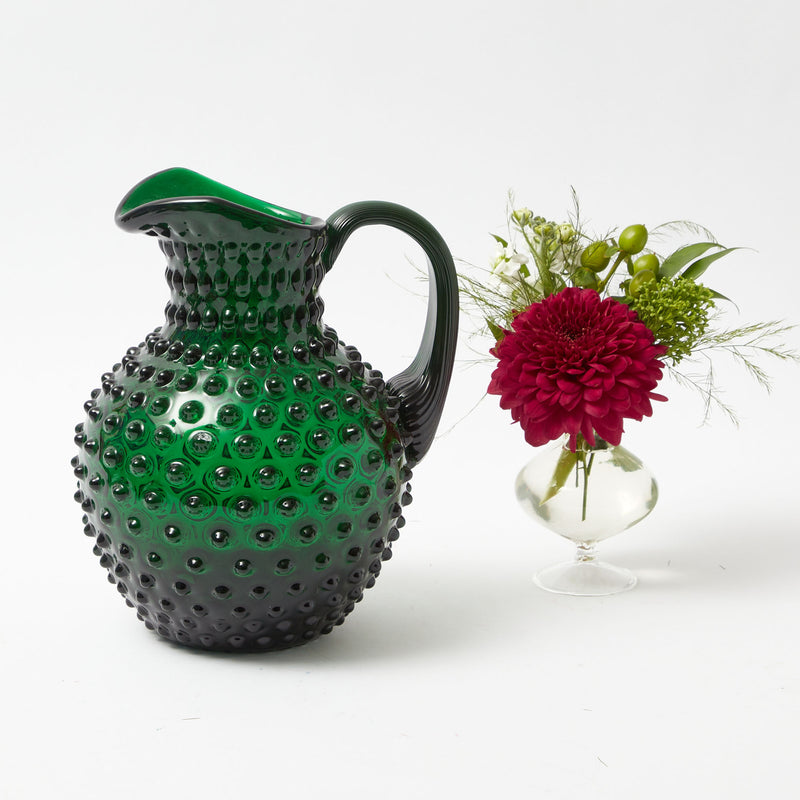 Elevate your Christmas gatherings with the sophisticated beauty of our 12-Piece Emerald Green Hobnail Glasses & Jug Set - a symbol of holiday grace, offering both glasses and a jug for a complete table setting.