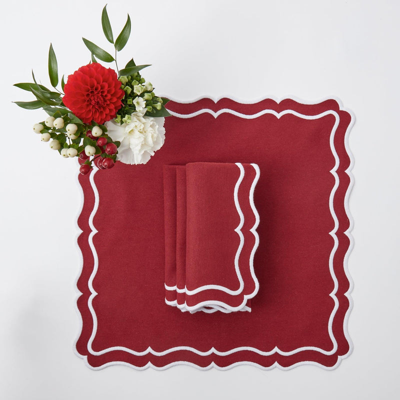 Elevate your Christmas table with the whimsical and enchanting Katherine Berry Red Placemats & Napkins Set - a simple yet stylish statement of holiday sophistication.