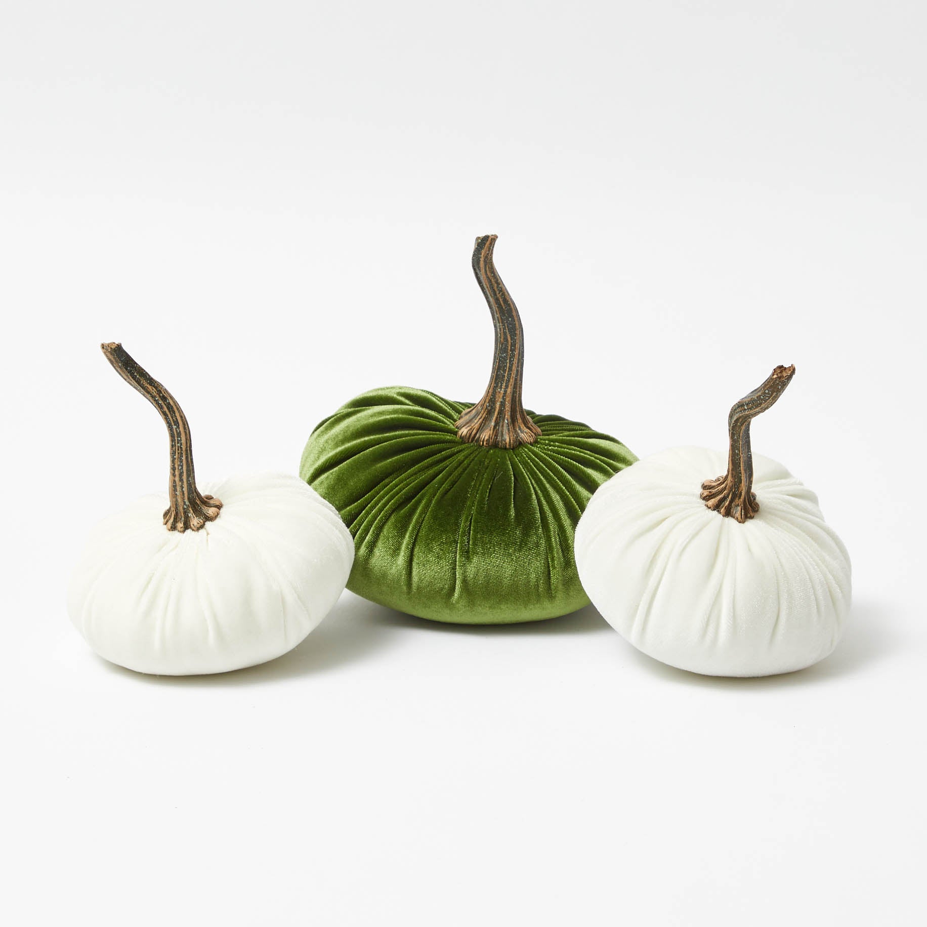 Collection of moss green and white velvet pumpkins for seasonal decor.