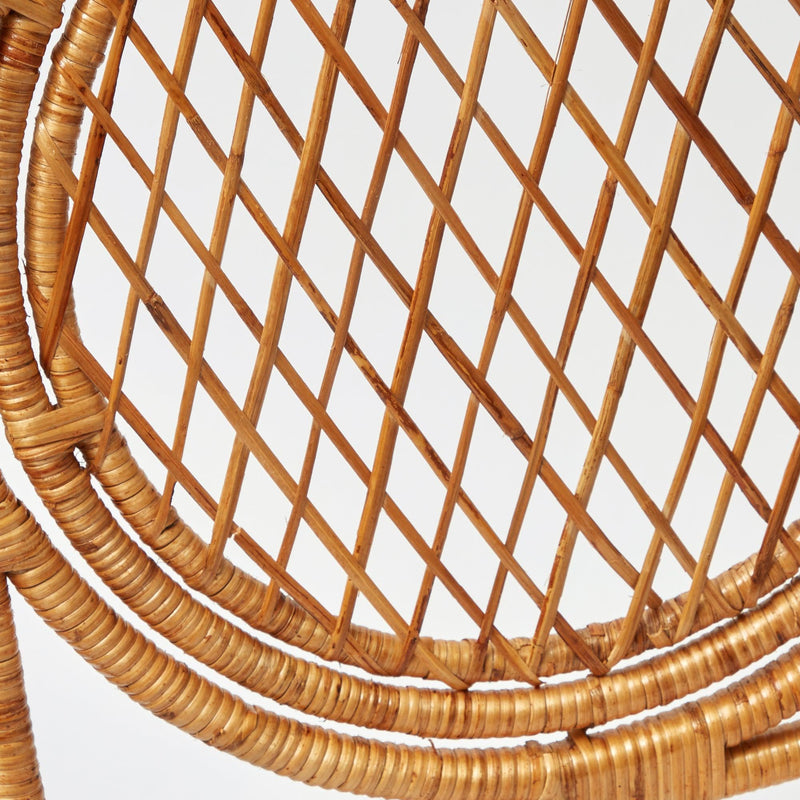 Elevate your interior decor with the whimsical and enchanting Vivienne Rattan Chair - a simple yet stylish statement of coastal sophistication.