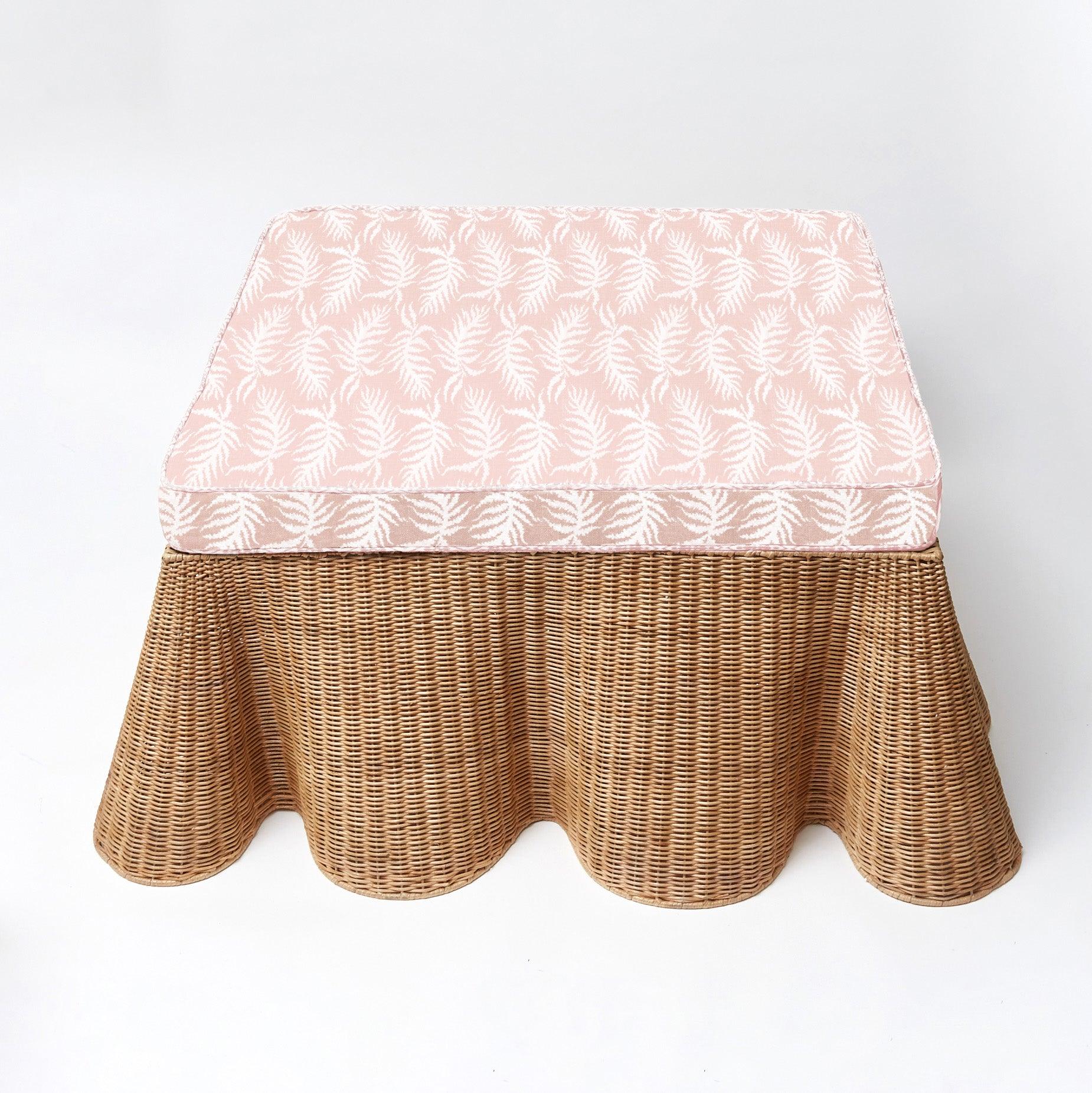 Make your living space more versatile and stylish with the Vivienne Rattan Scalloped Ottoman - a delightful addition that adds a dash of coastal charm, extra seating, and a touch of natural sophistication to your home.