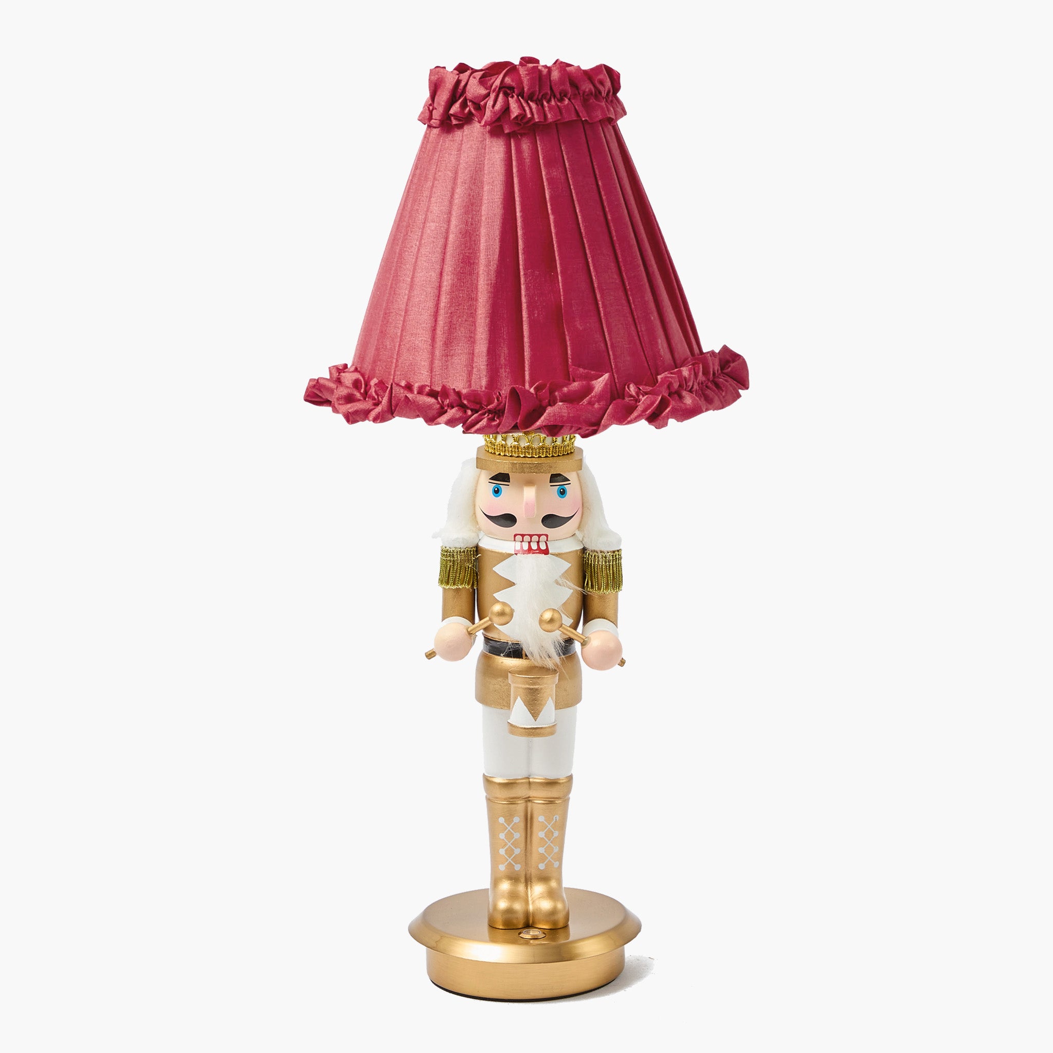 Nutcracker figurine with a pink lamp shade on a white background