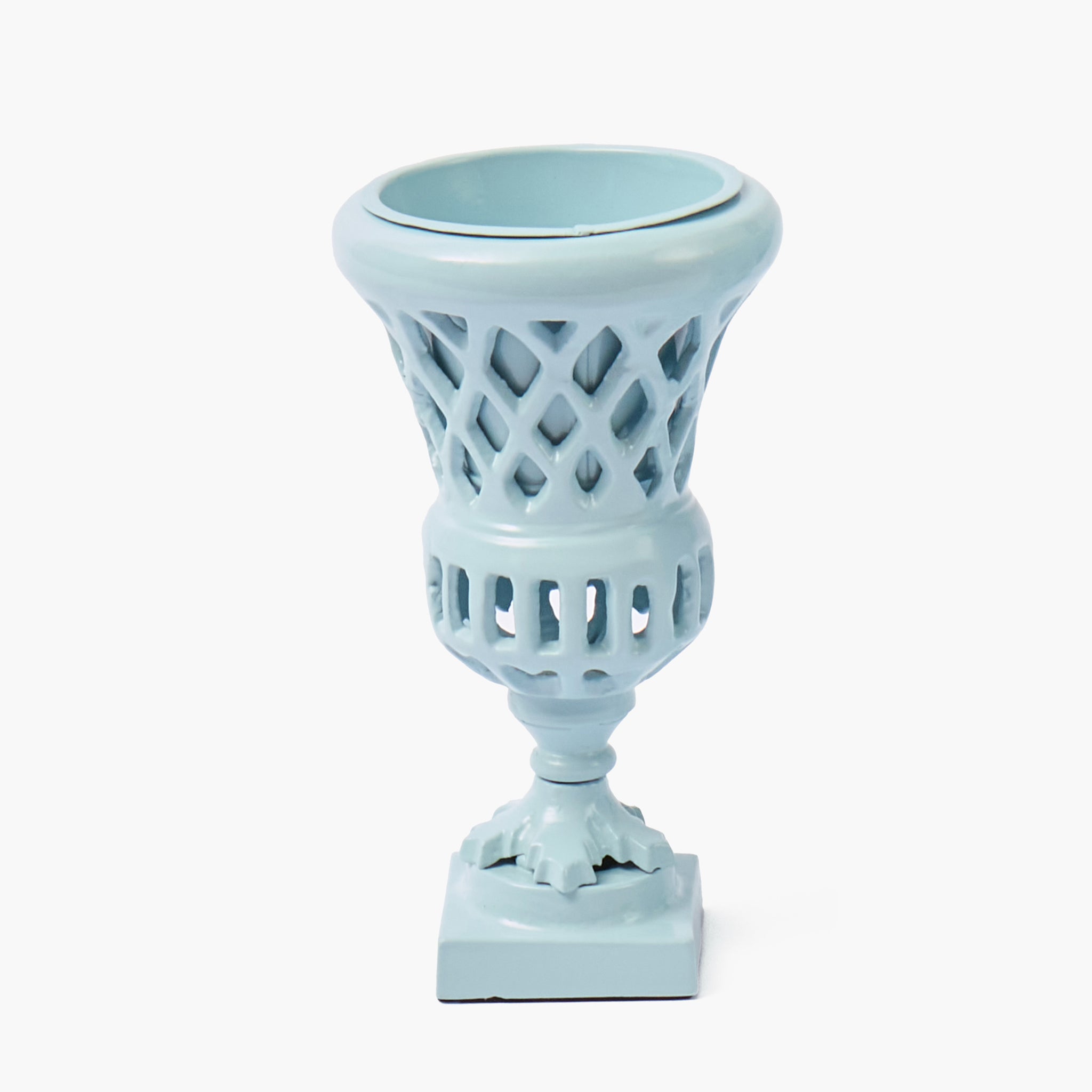 Two light blue ceramic candle holders with lattice designs on a white background