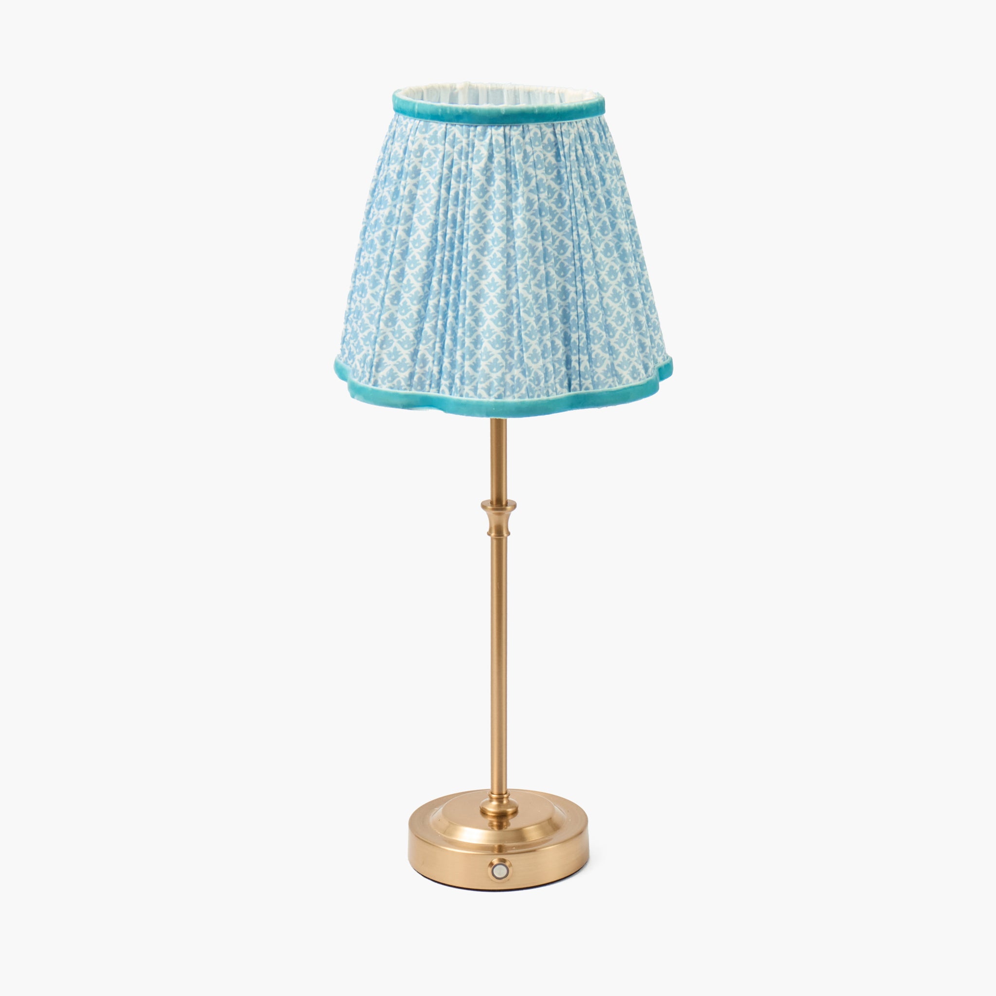 Small lamp with a blue patterned shade on a white background