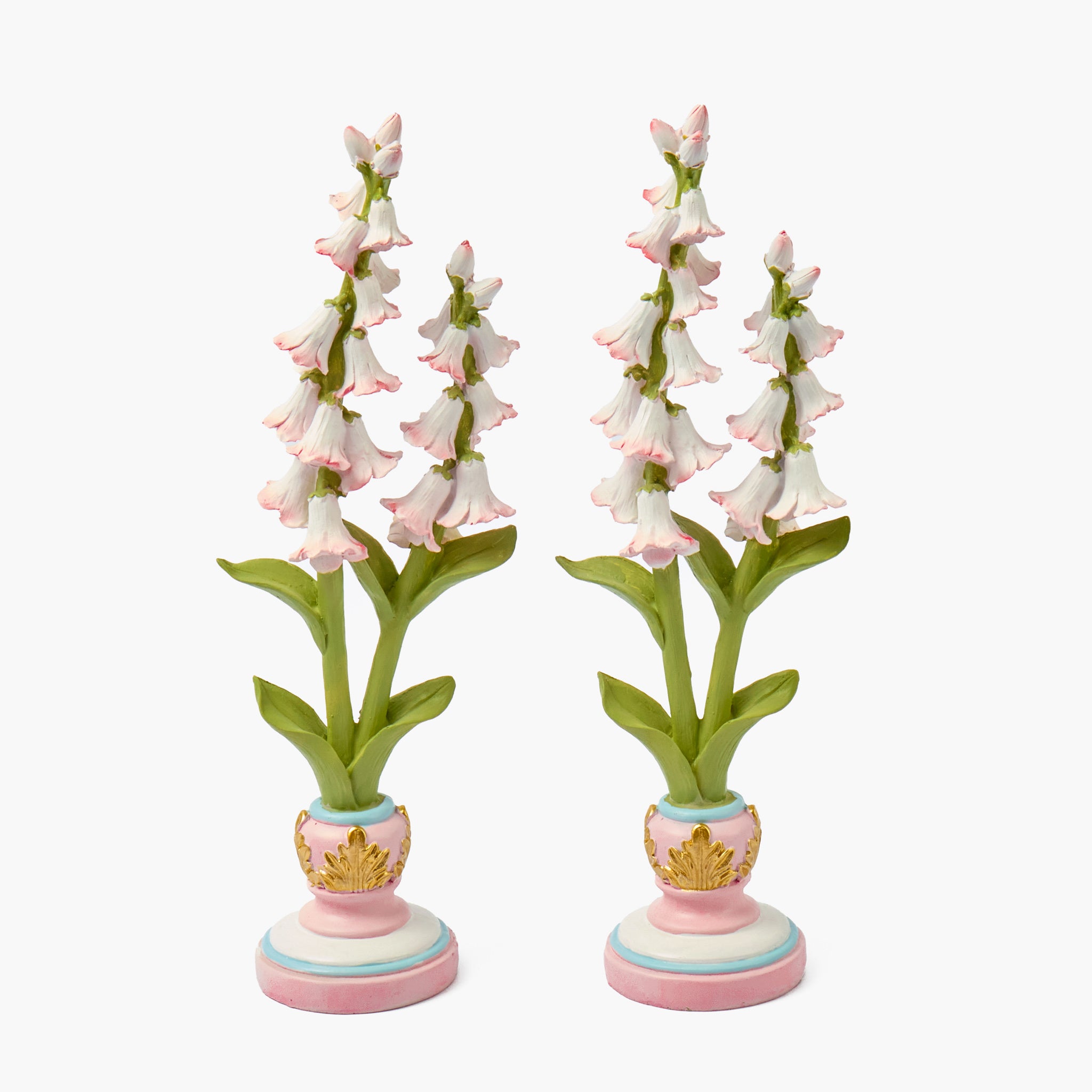 Two decorative floral stands with pink and white flowers on a white background