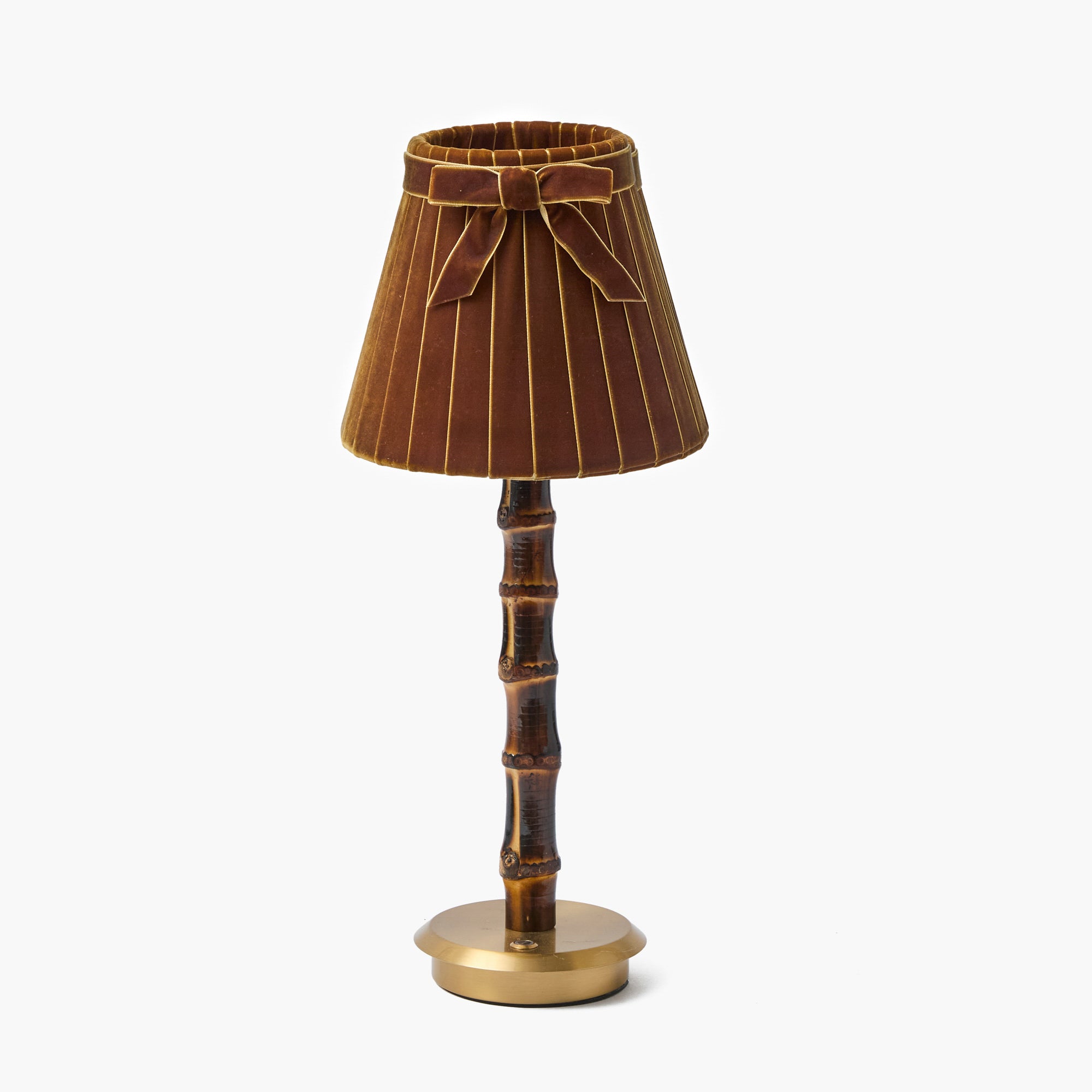 Decorative lamp with brown pleated shade and bamboo-like base on a white background