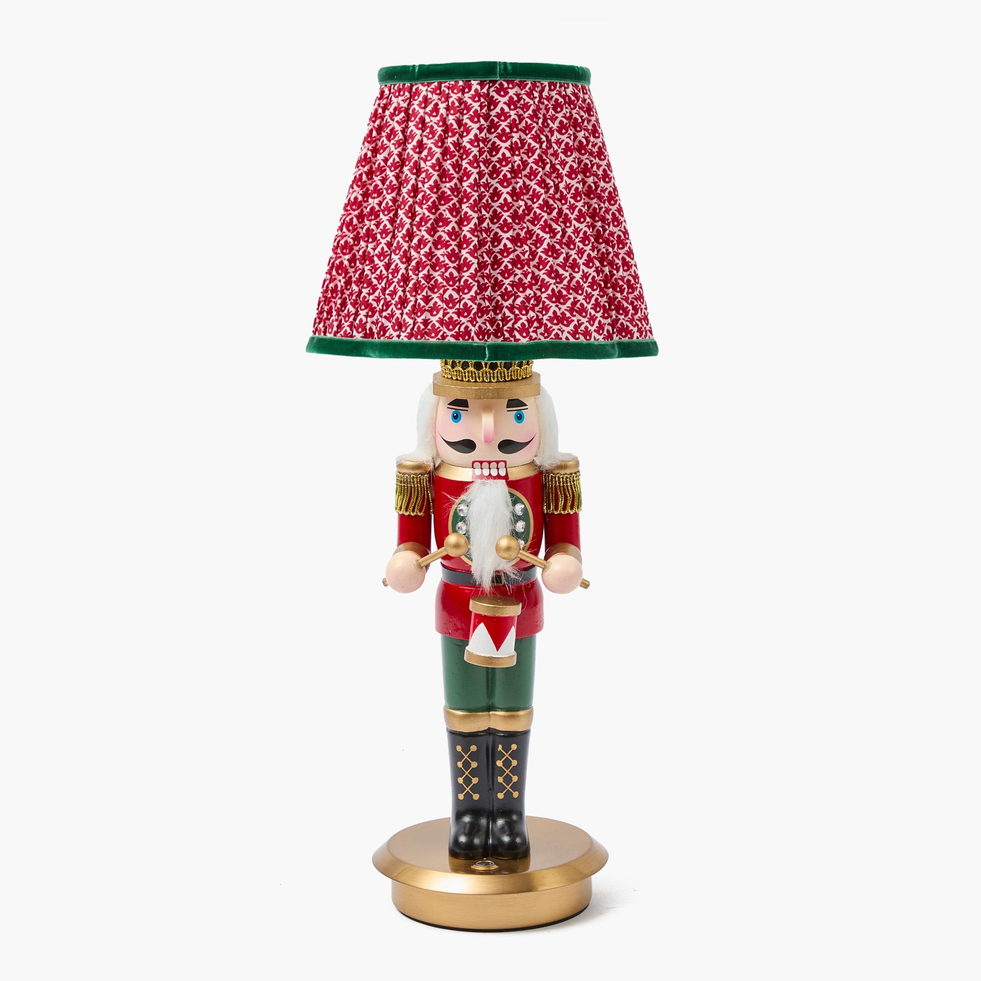 Nutcracker figurine with a red lampshade on a white background