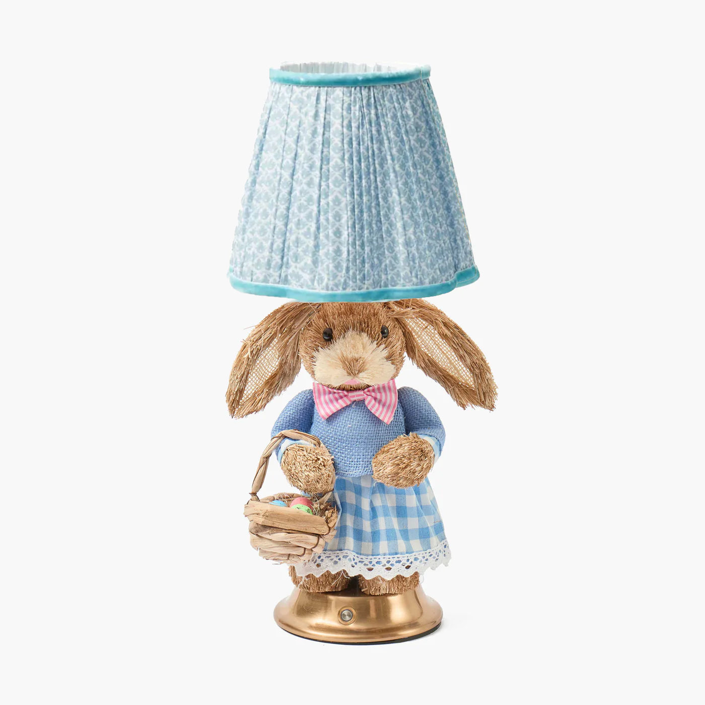 Decorative lamp with a rabbit figure holding a basket on a white background