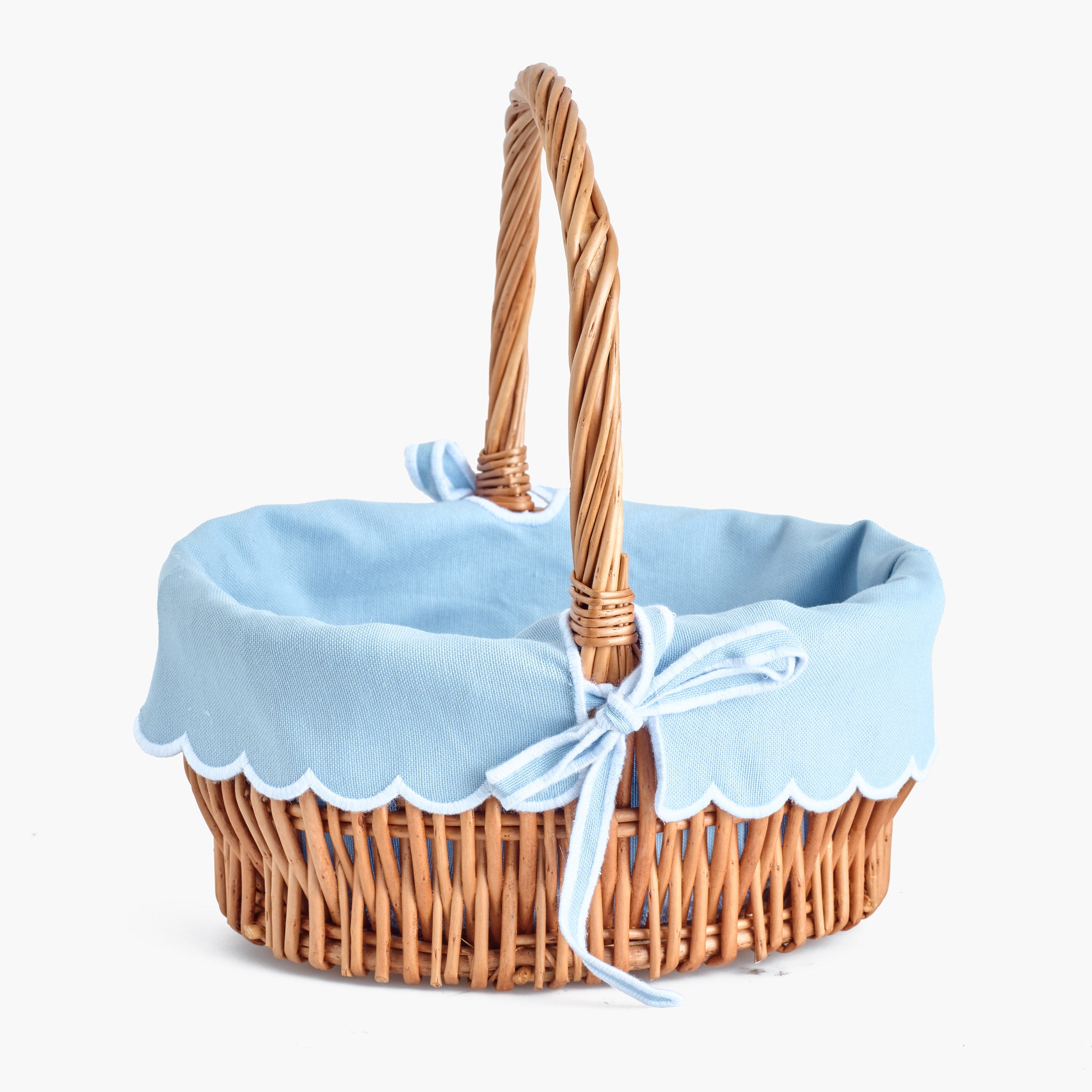 Wicker basket with a blue liner and white trim on a white background