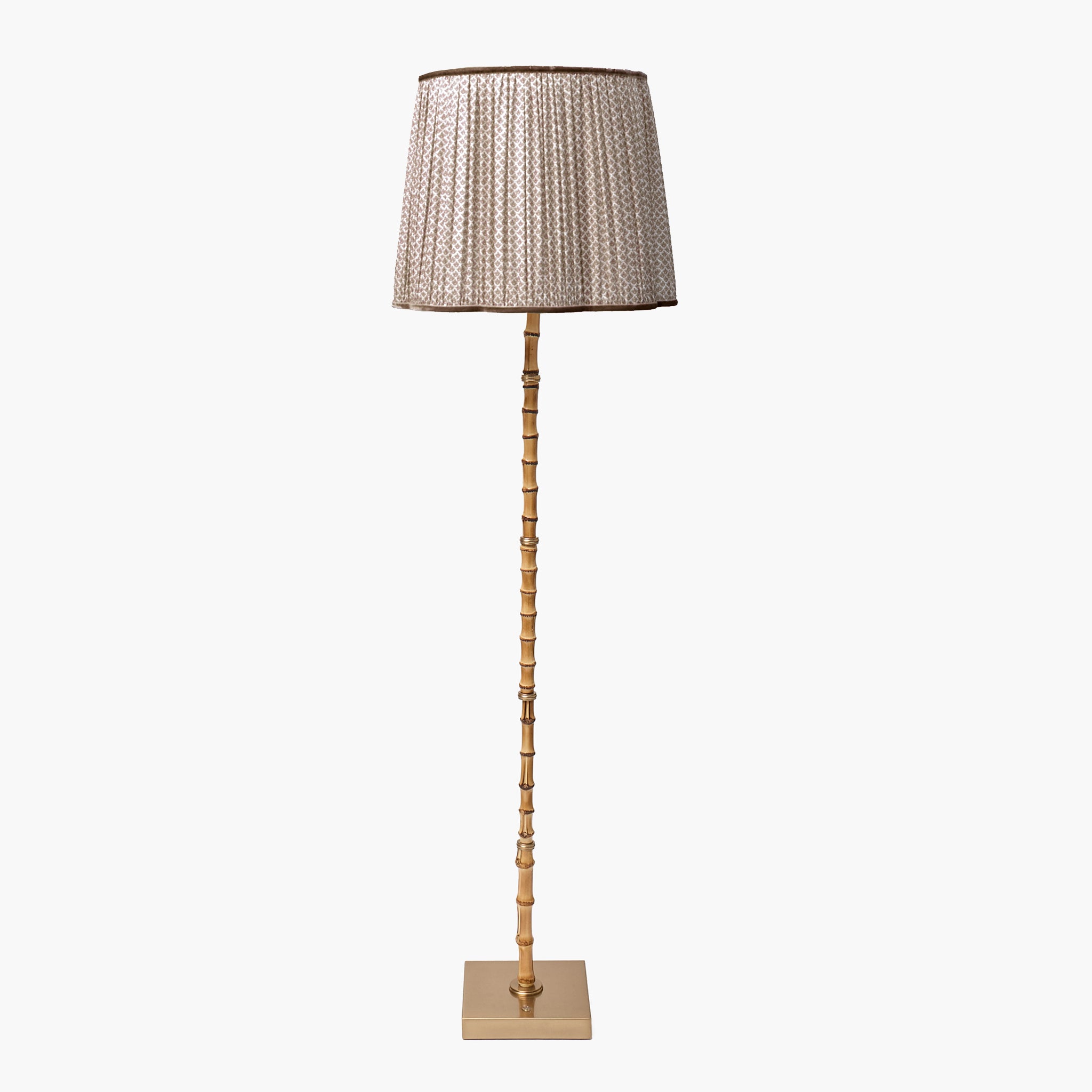Floor lamp with a decorative shade on a white background