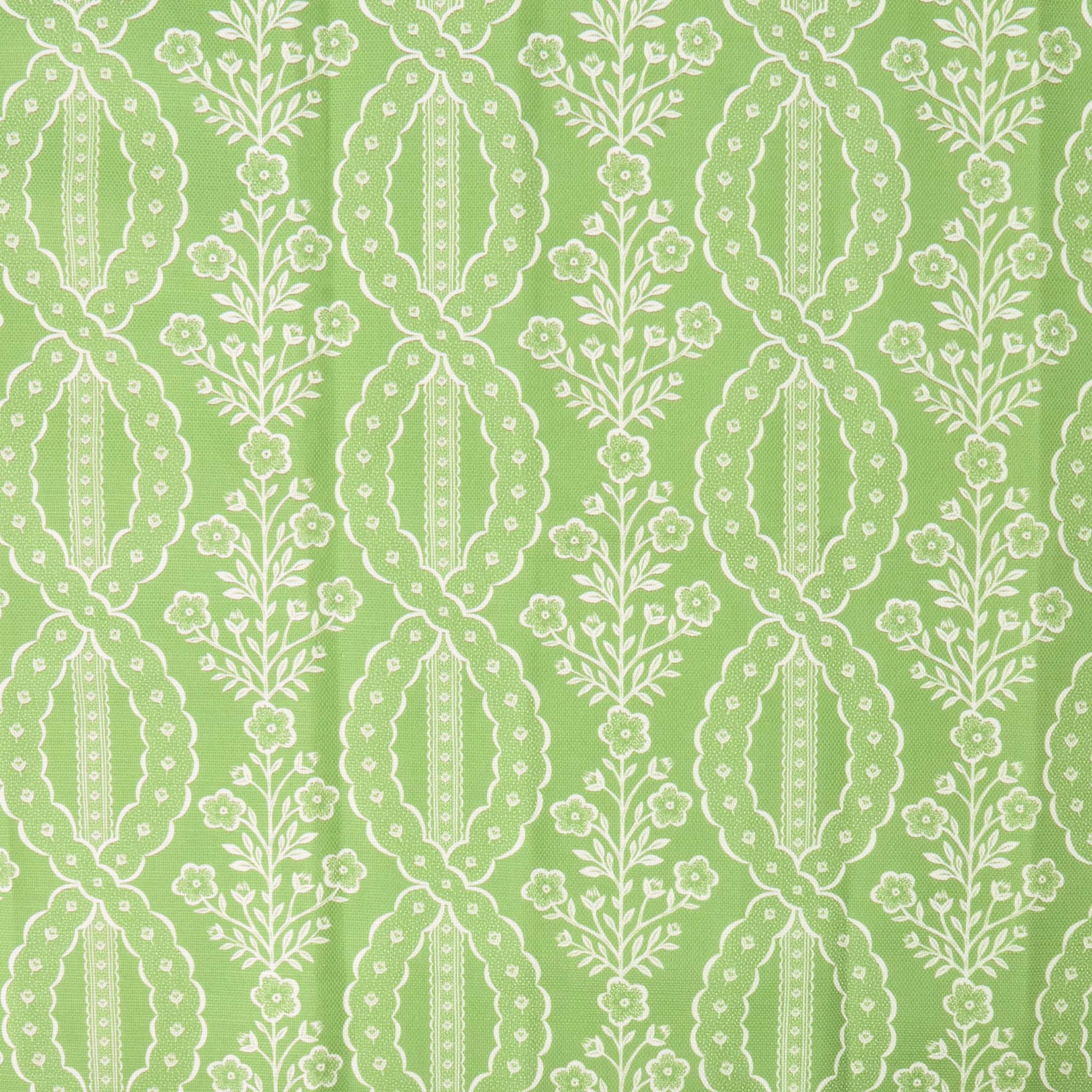 White floral and leaf pattern on a green background