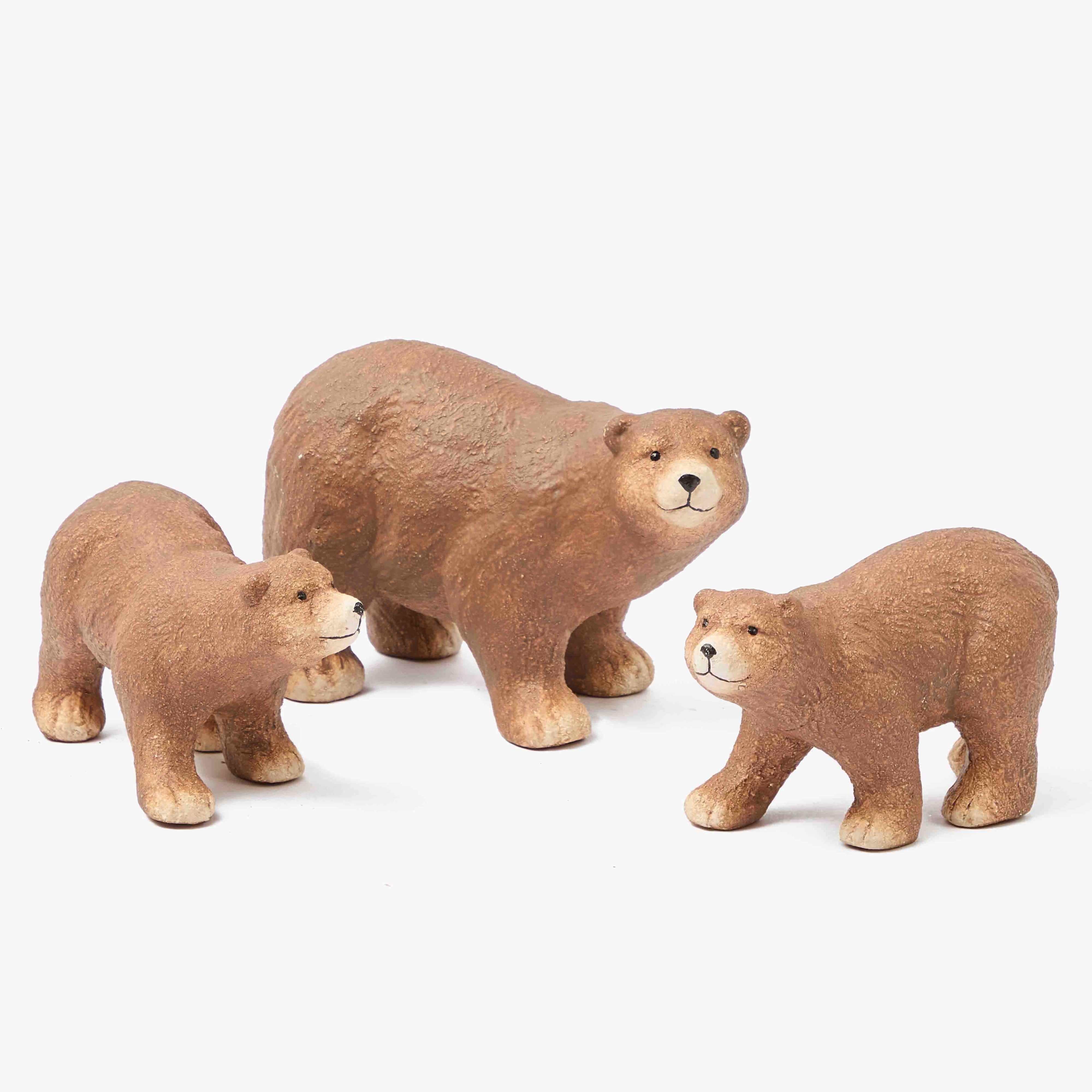 Three brown bear figurines on a white background