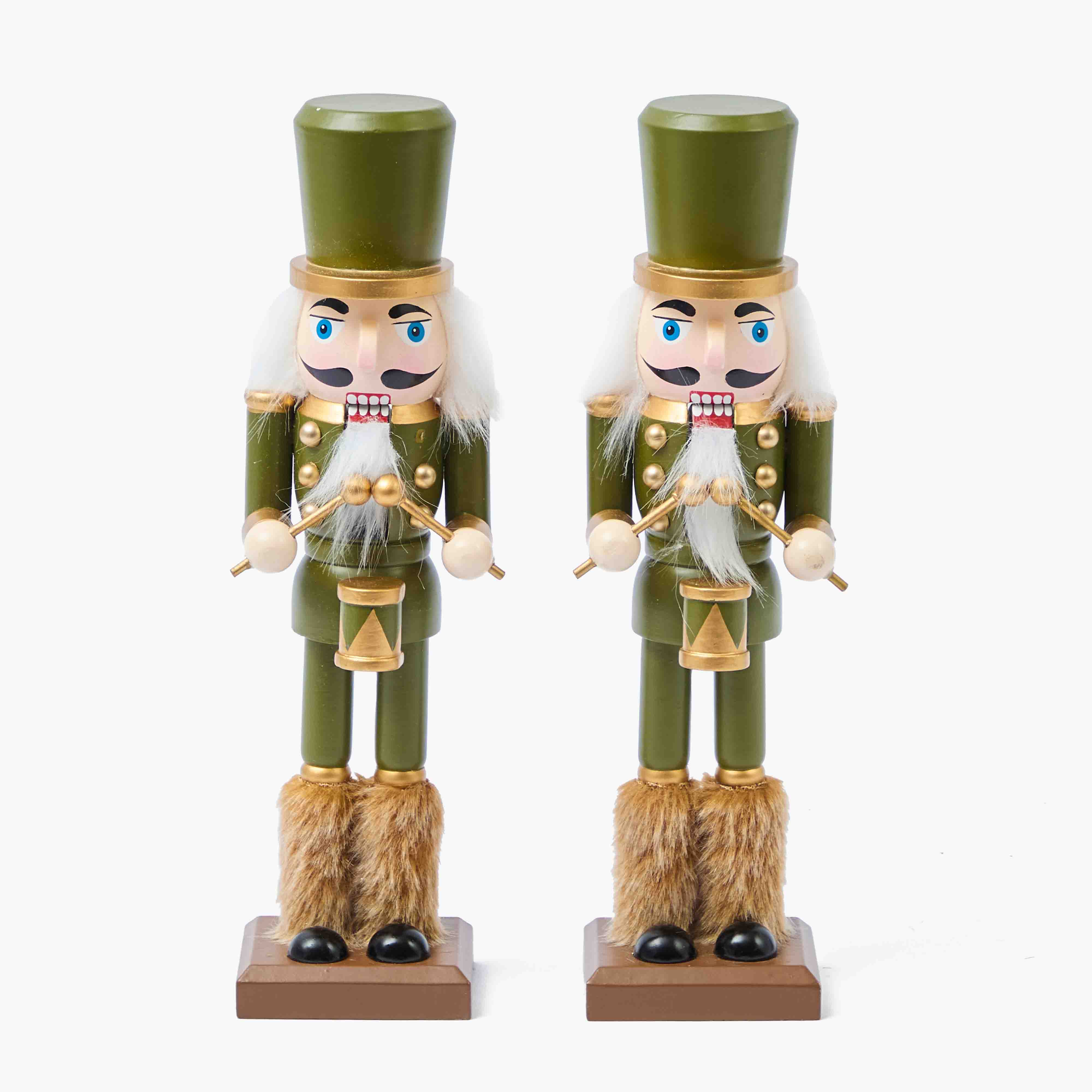 Two green nutcrackers with fur boots on a white background