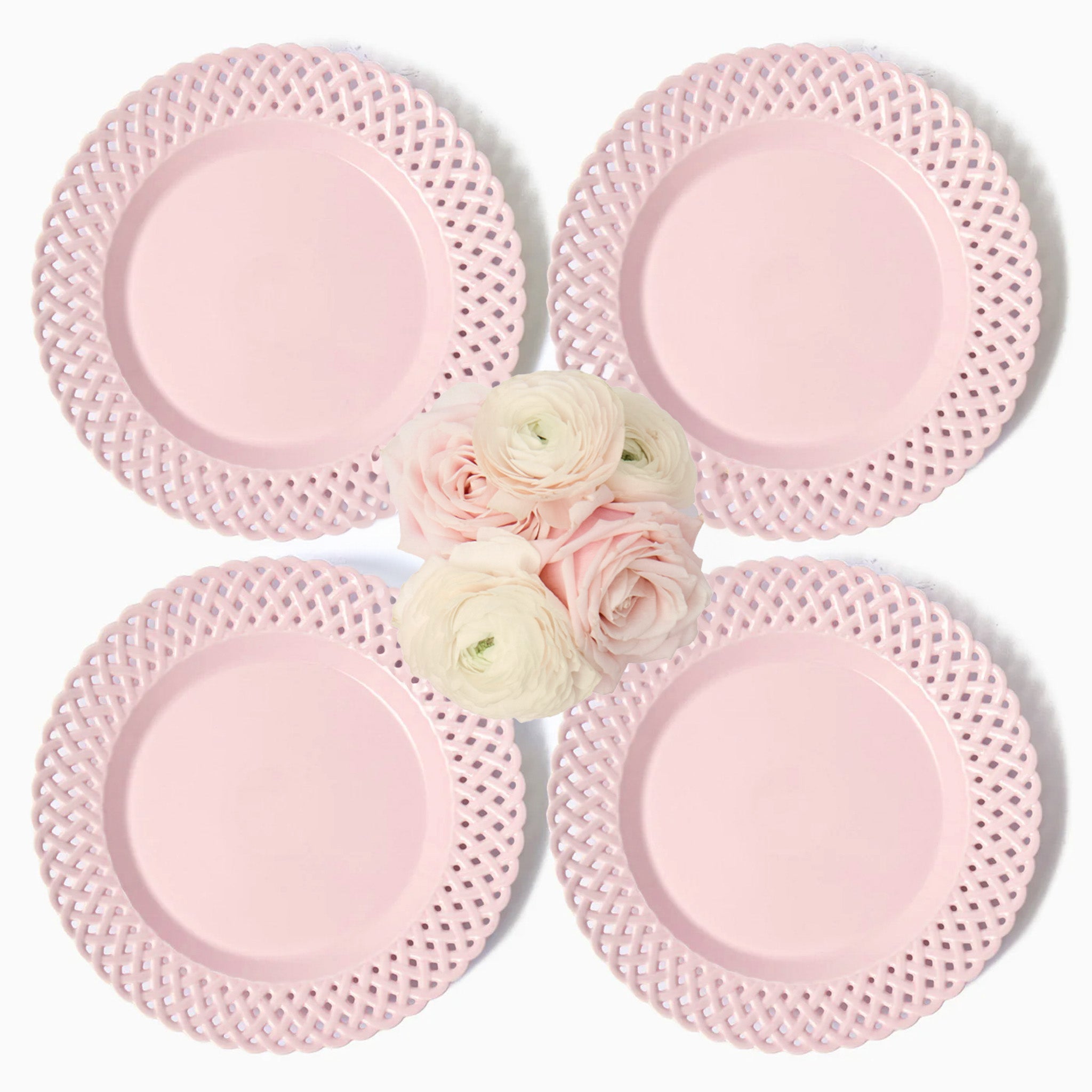 Four pink lace plates with a cluster of flowers in the center on a white background