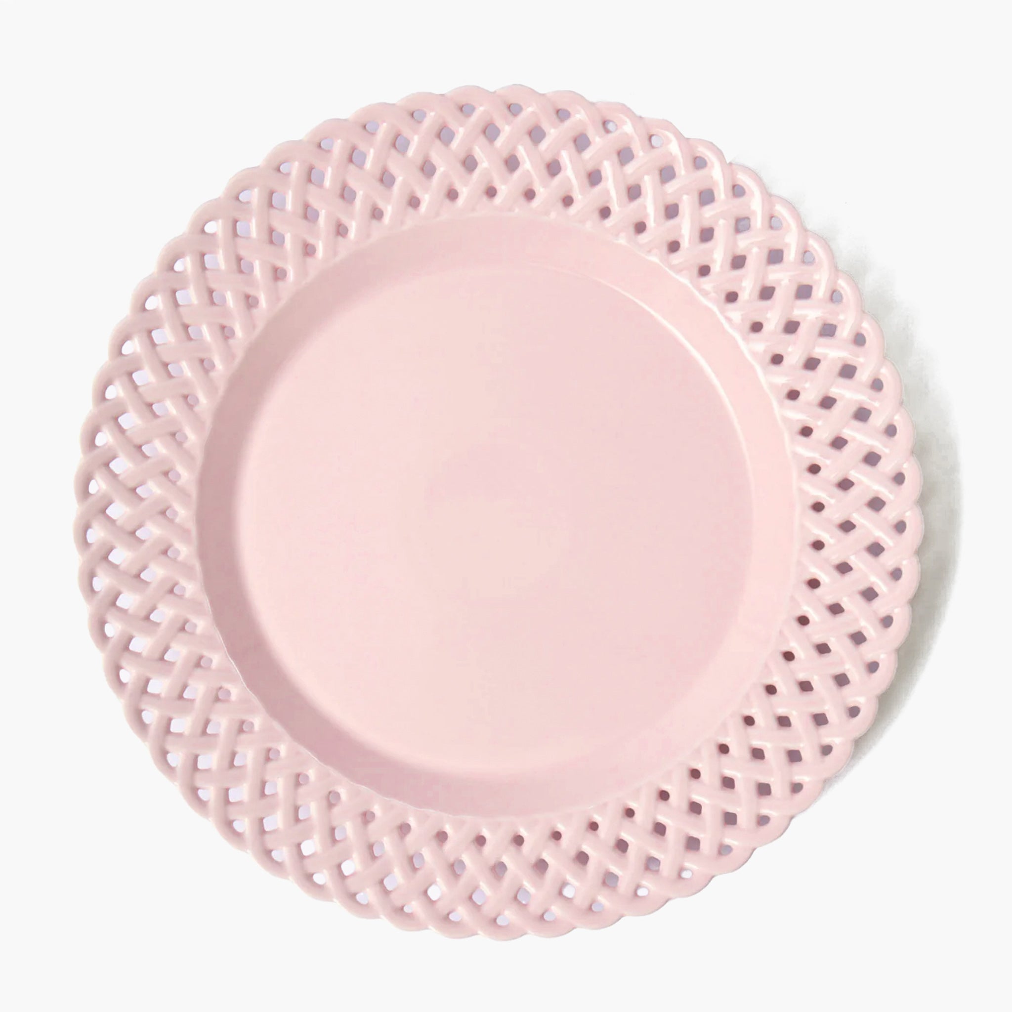Pink plate with decorative lace edge on a white background