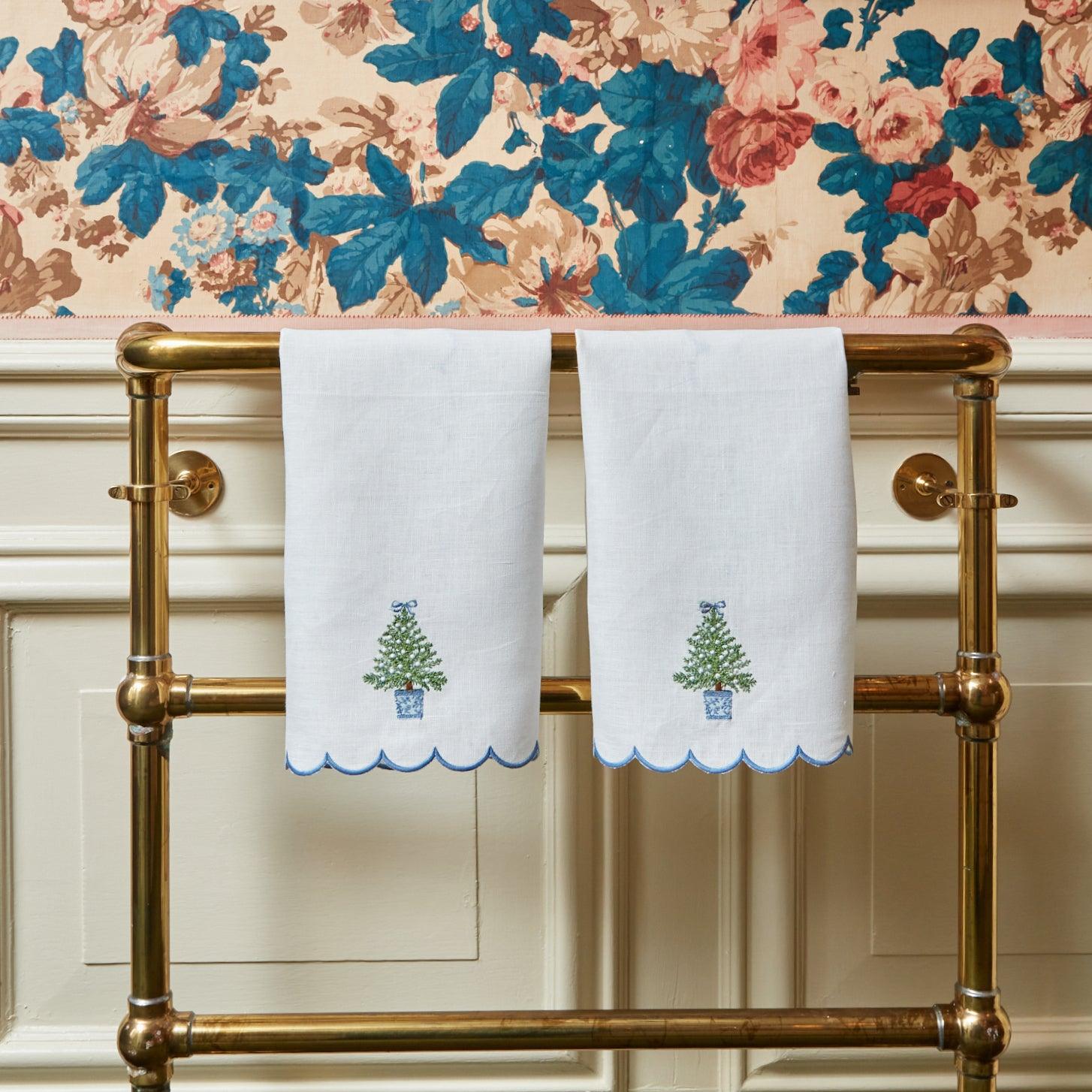 Elevate your Christmas decorations with the whimsical and enchanting Embroidered Christmas Tree Linen Hand Towel - a simple yet stylish statement of holiday sophistication.