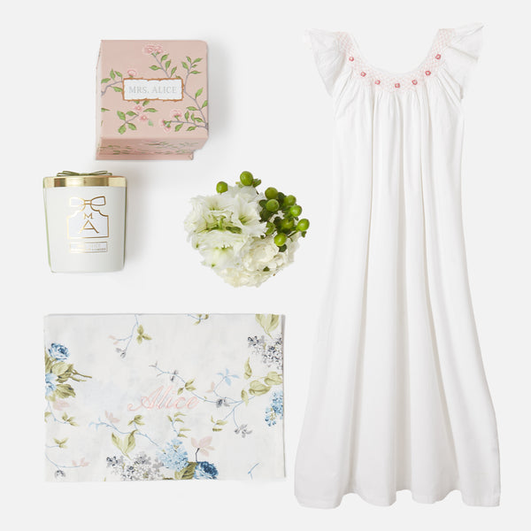 Immerse yourself in tranquility with the Bonne Nuit Pink Giftscape, highlighting a Pink Sleeveless Nightdress, a Fragrant Rose Petal Scented Candle, and a Monogrammable Pink Chintz Pochette.