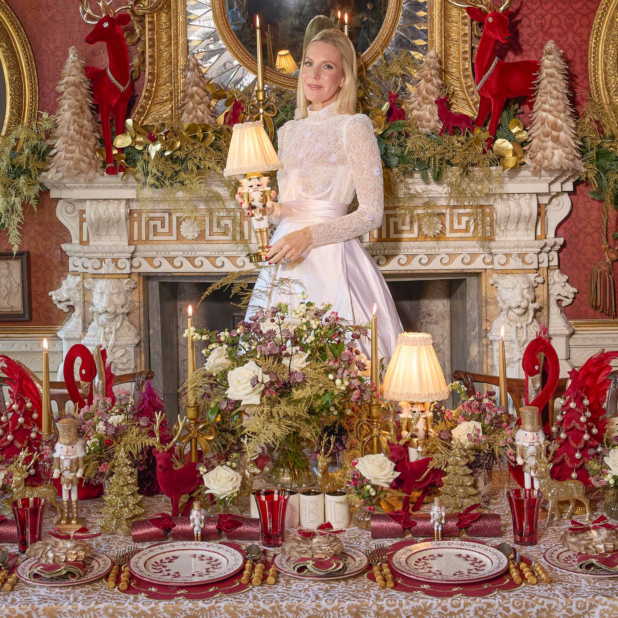 Alice standing in a lavishly Christmas decorated room with a table set for a festive meal.