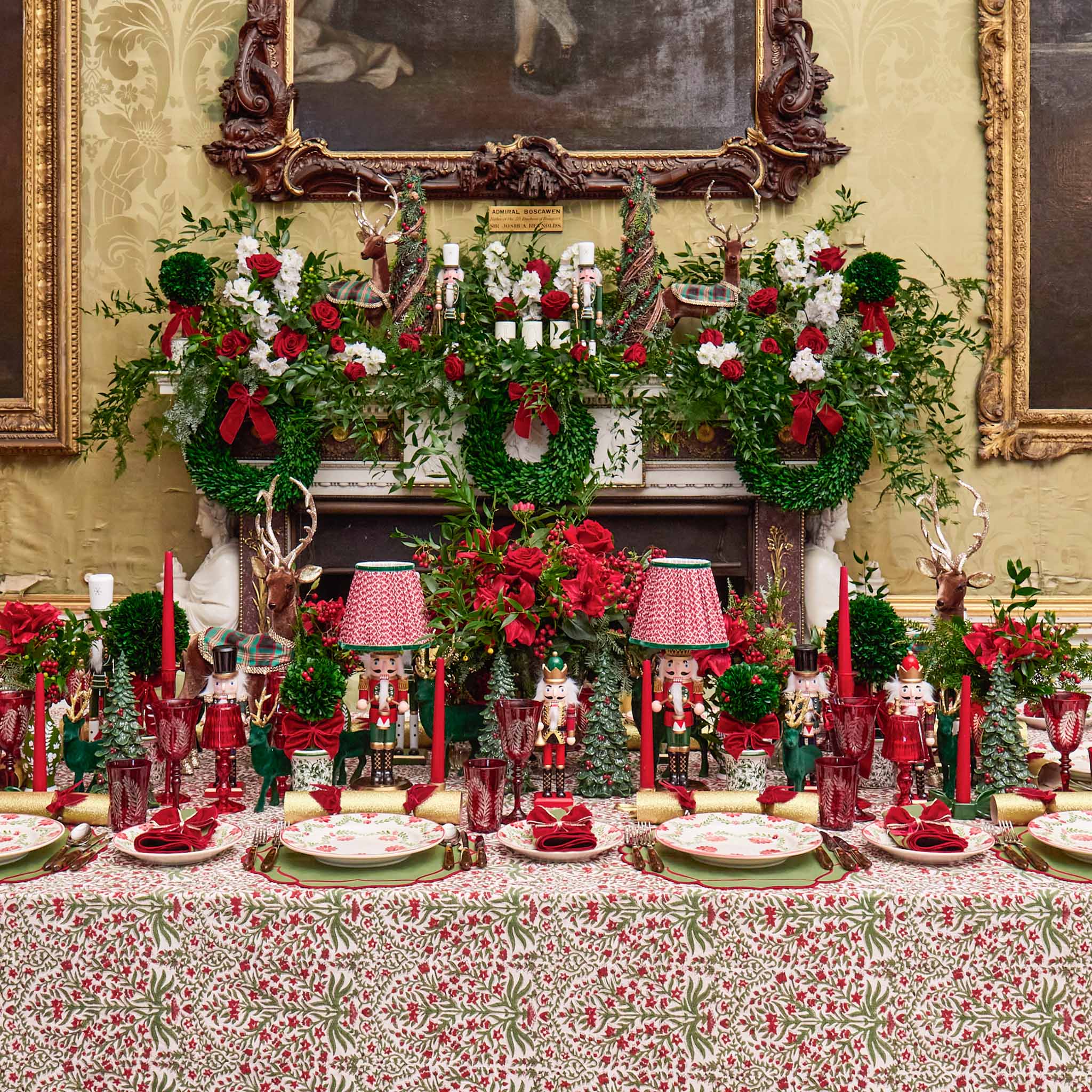 Decorative Christmas table setting with red and green theme in a formal room.