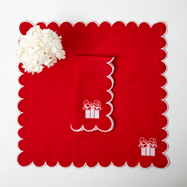 Set of 4 red linen napkins with elegant embroidered festive designs.