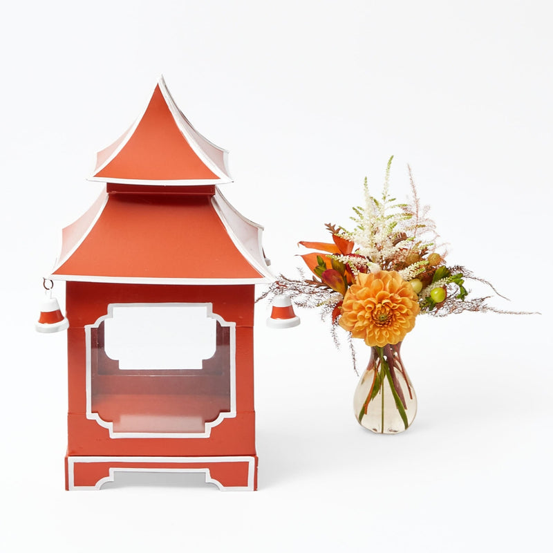 Lantern in burnt orange, fashioned in a pagoda-style silhouette.