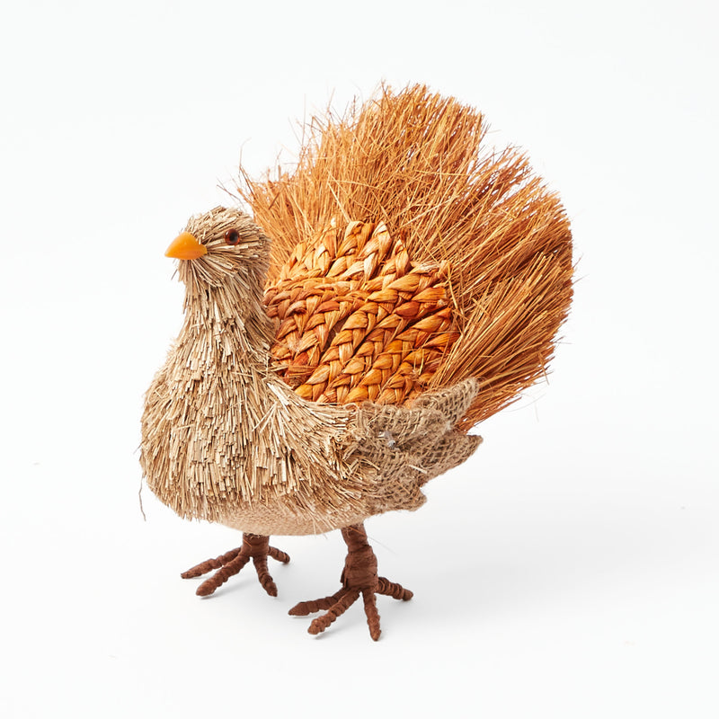 Artistic turkey sculpture crafted from decorative raffia material.