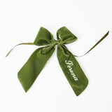 Elevate your table setting with the Personalizable Forest Green Napkin Bow, a charming accessory that adds a personalized touch and a touch of natural beauty to your dining decor.