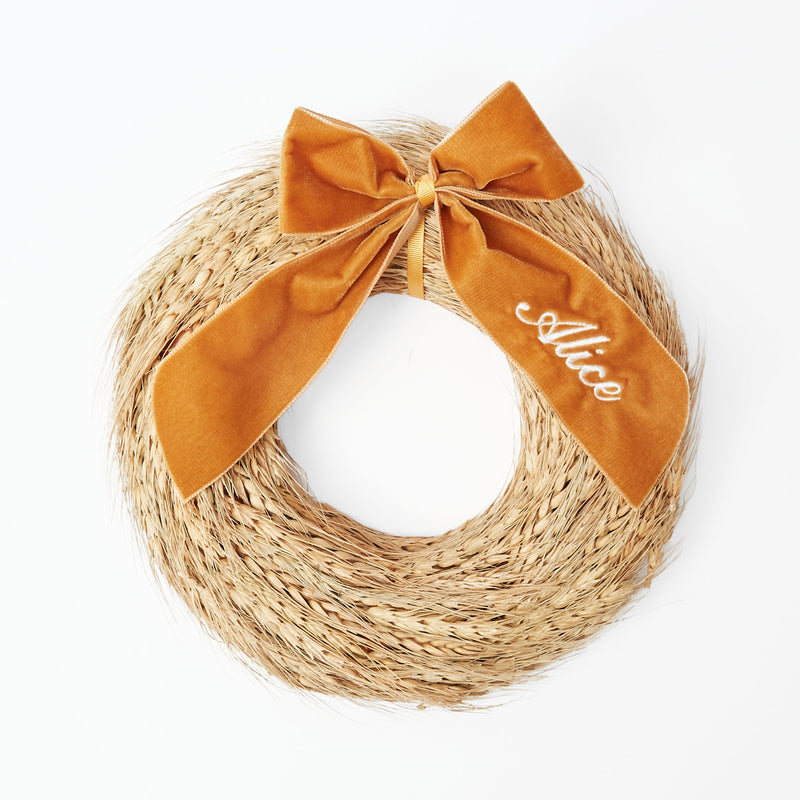 Wreath crafted from golden wheat in a medium size for decoration.