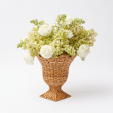 Tiny urn vase in natural rattan, ideal for minimalist decor.