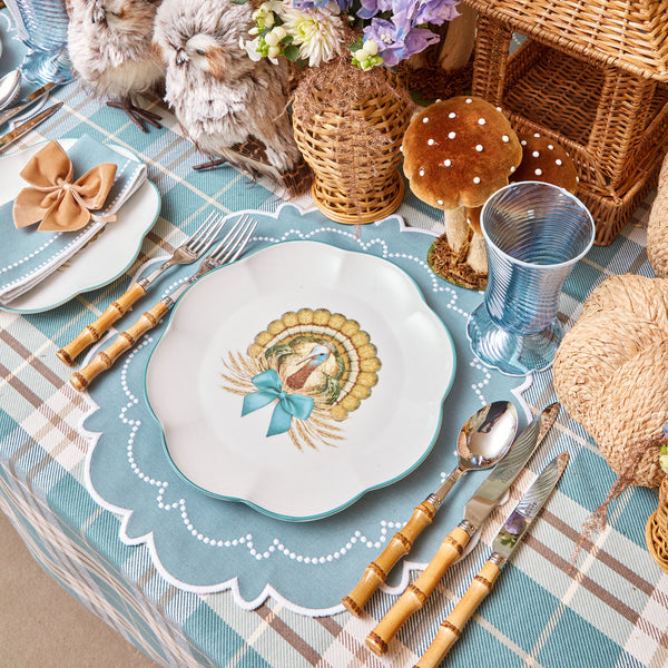 Dinner plate adorned with a scalloped edge and turkey motif.