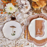 Sixteen plates, 8 for dinner and 8 for starters, adorned with scalloped mushroom motifs.