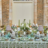 Four starter plates adorned with elegant olive and pomegranate motifs.
