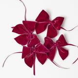 Elevate your table setting with Aubergine Napkin Bows (Set of 4), a touch of sophistication.
