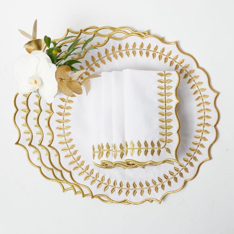 Create a refined and stylish ambiance with the White & Gold Laurel Placemats & Napkins, perfect for enhancing your dining table with a touch of classic elegance.