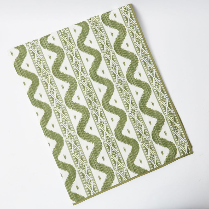 Delight in the trendy charm of the Olive Green Ikat Tablecloth, a unique and stylish piece that adds a touch of modern sophistication to your dining occasions.