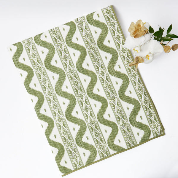 Elevate your dining experience with the Olive Green Ikat Tablecloth, a stylish addition that brings a touch of elegance to your table.