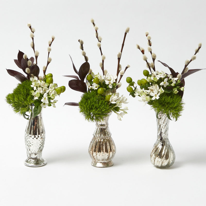 Elevate your floral arrangements with the Trio of Mercury Bud Vases, a set that infuses your space with chic elegance and a touch of vintage charm.