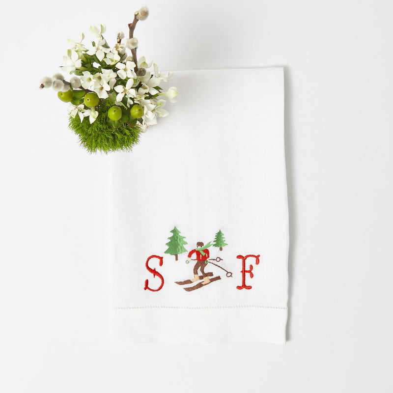 Elevate your bathroom decor with the Embroidered Skier White Linen Hand Towel, a stylish and seasonal addition that adds a touch of winter charm.