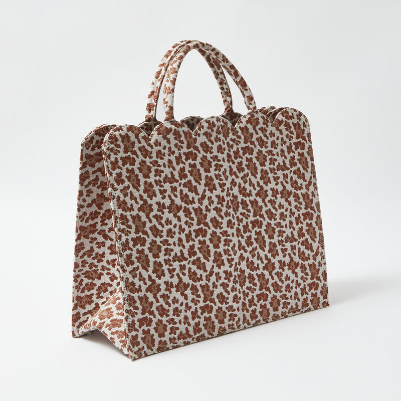 Impress your friends with the fierce charm of the Mrs. Alice Tote Bag in Leopard, a stylish tote that adds a touch of exotic allure to your everyday look.